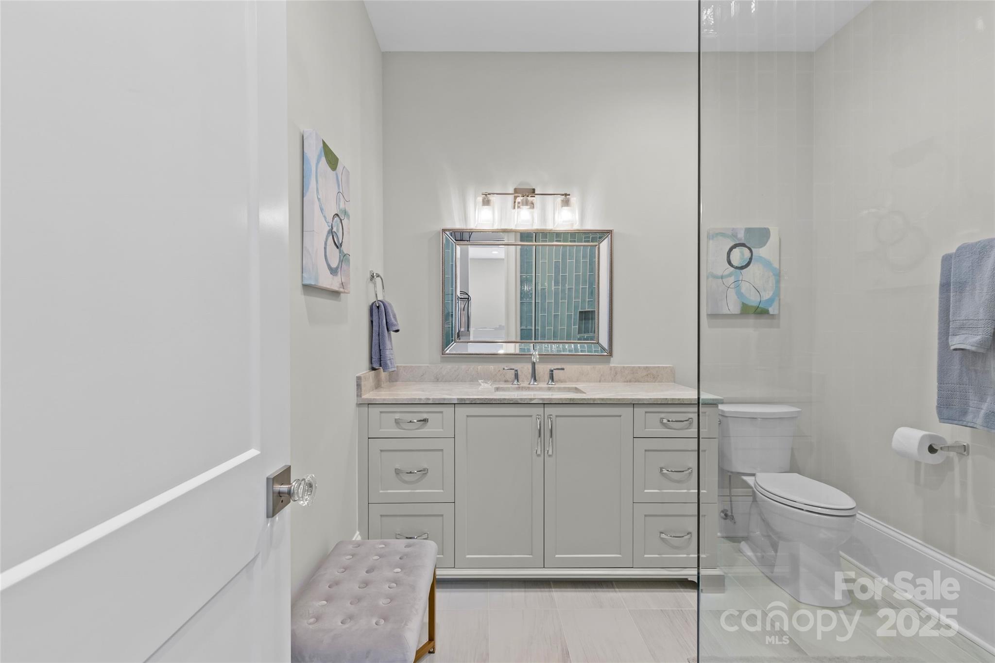 1500 Queens Road, Unit 104 Charlotte, NC 28207 - Photo 14 of 43 a bathroom with a toilet sink and mirror