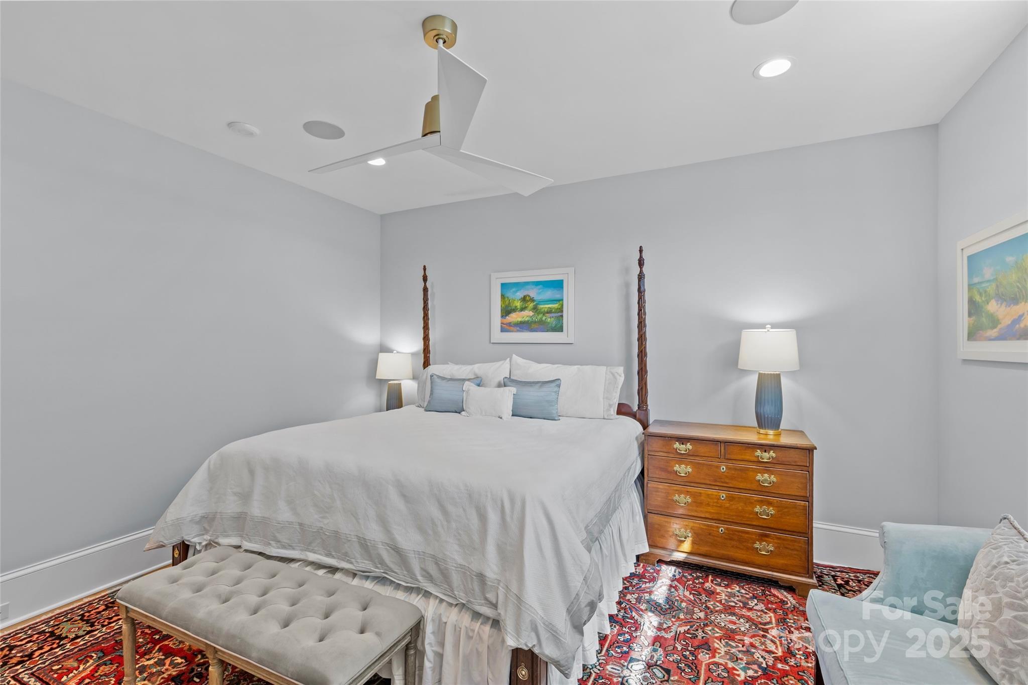 1500 Queens Road, Unit 104 Charlotte, NC 28207 - Photo 27 of 43 a bedroom with a bed and a lamp on dresser