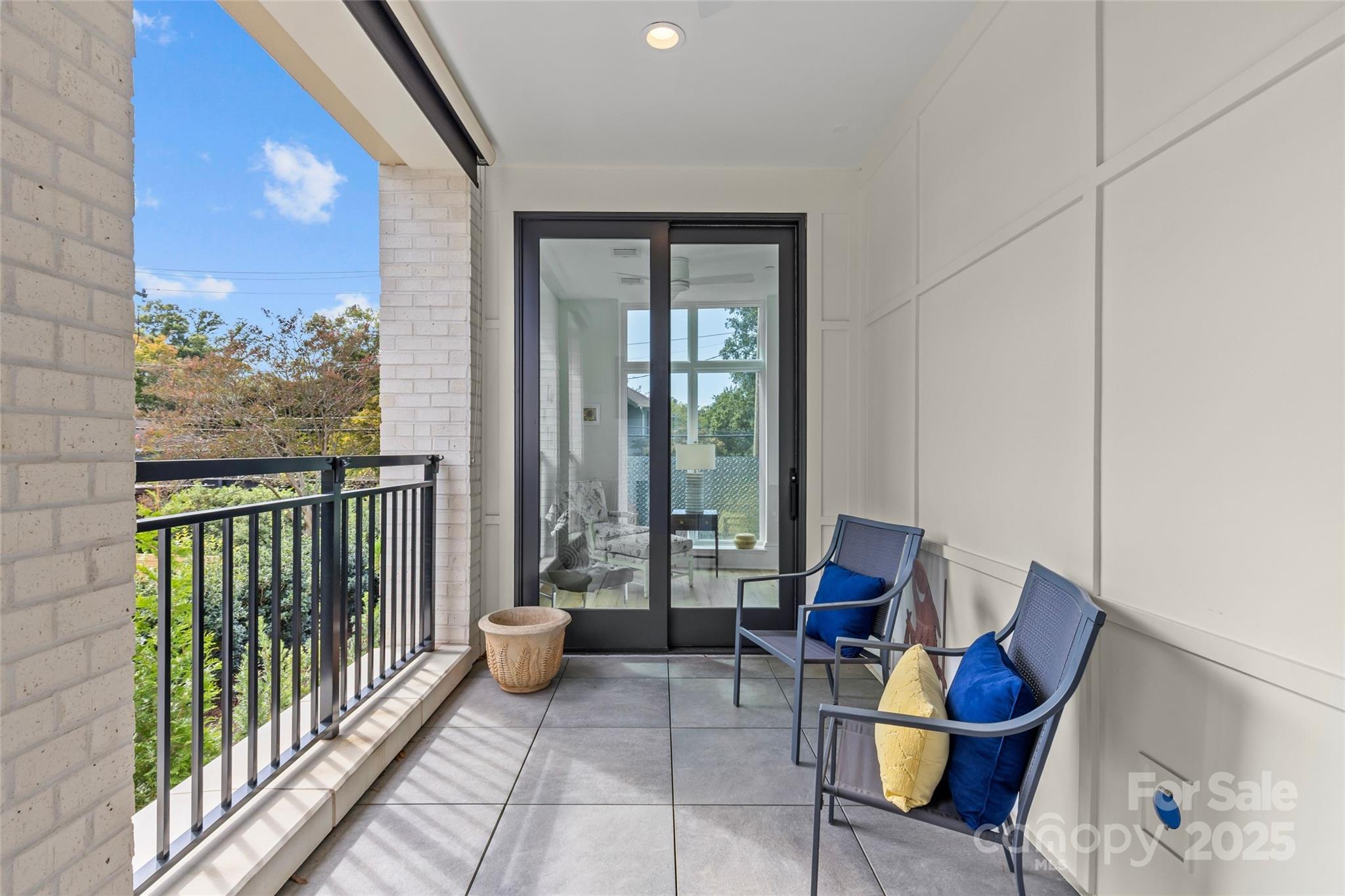 1500 Queens Road, Unit 104 Charlotte, NC 28207 - Photo 31 of 43 a living room with furniture and a floor to ceiling window