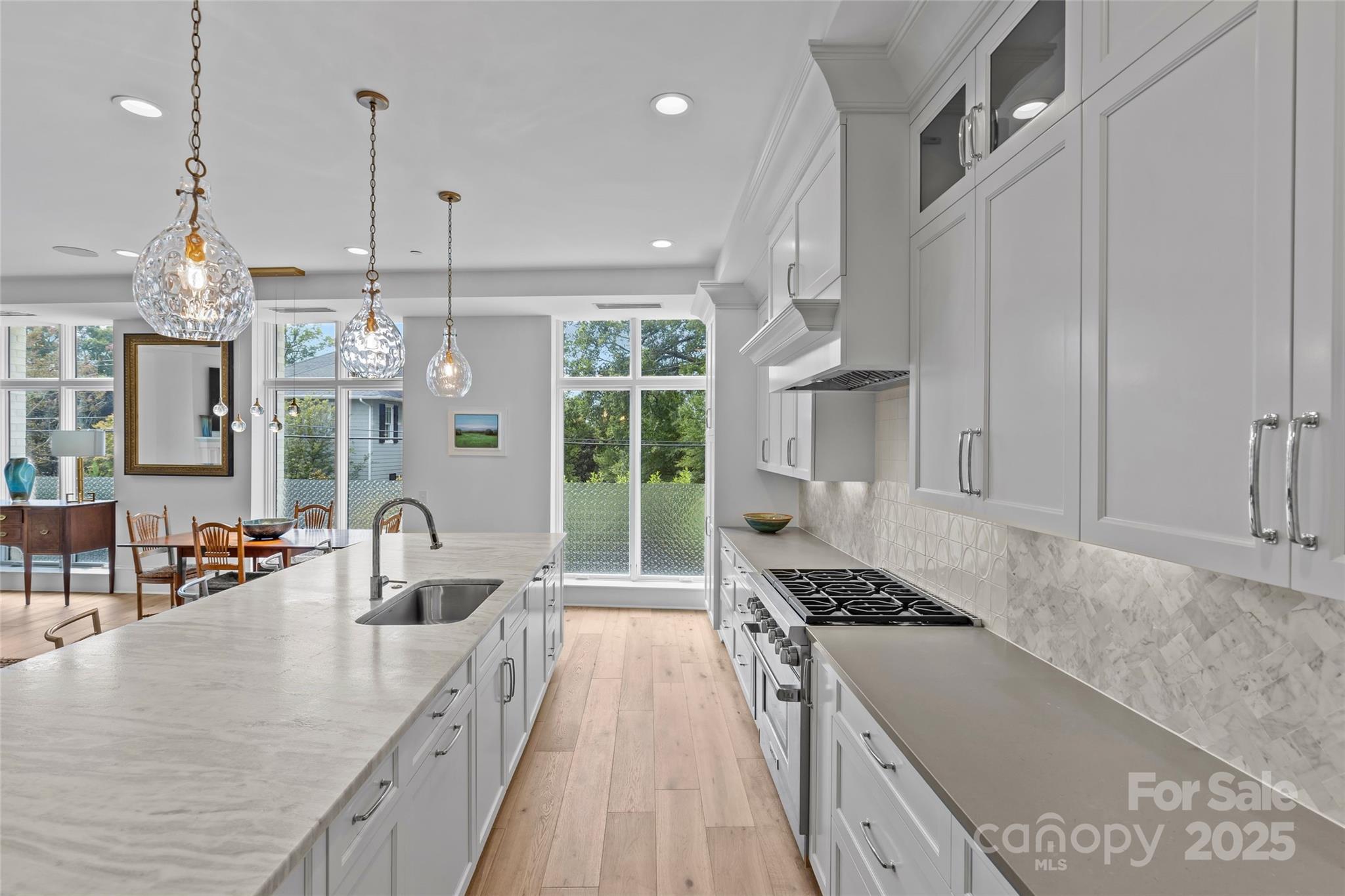 1500 Queens Road, Unit 104 Charlotte, NC 28207 - Photo 9 of 43 a kitchen with stainless steel appliances granite countertop a sink stove and cabinets
