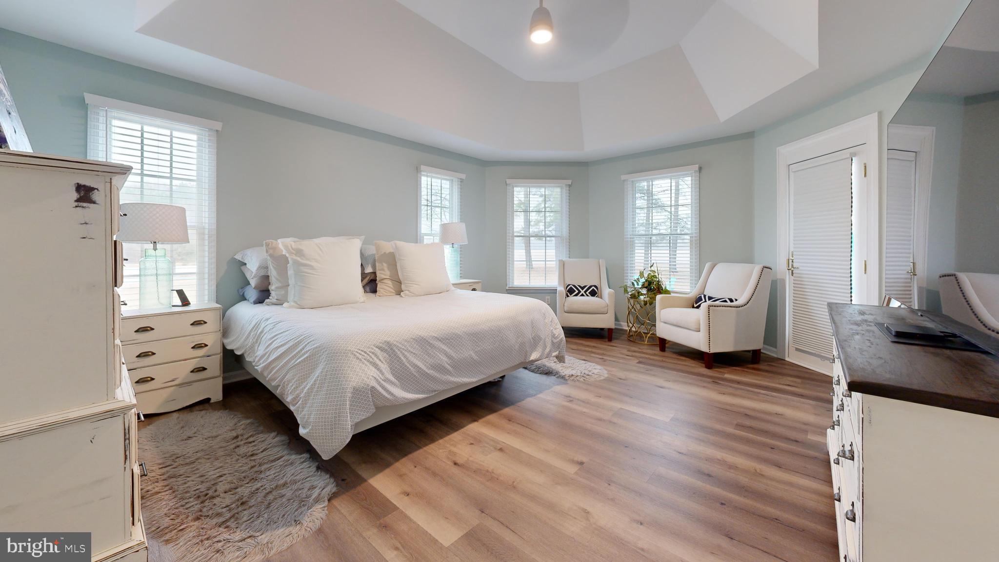 28715 Jacks Field Road Wye Mills, MD 21679 - Photo 14 of 27 a spacious bedroom with a bed and wooden floor