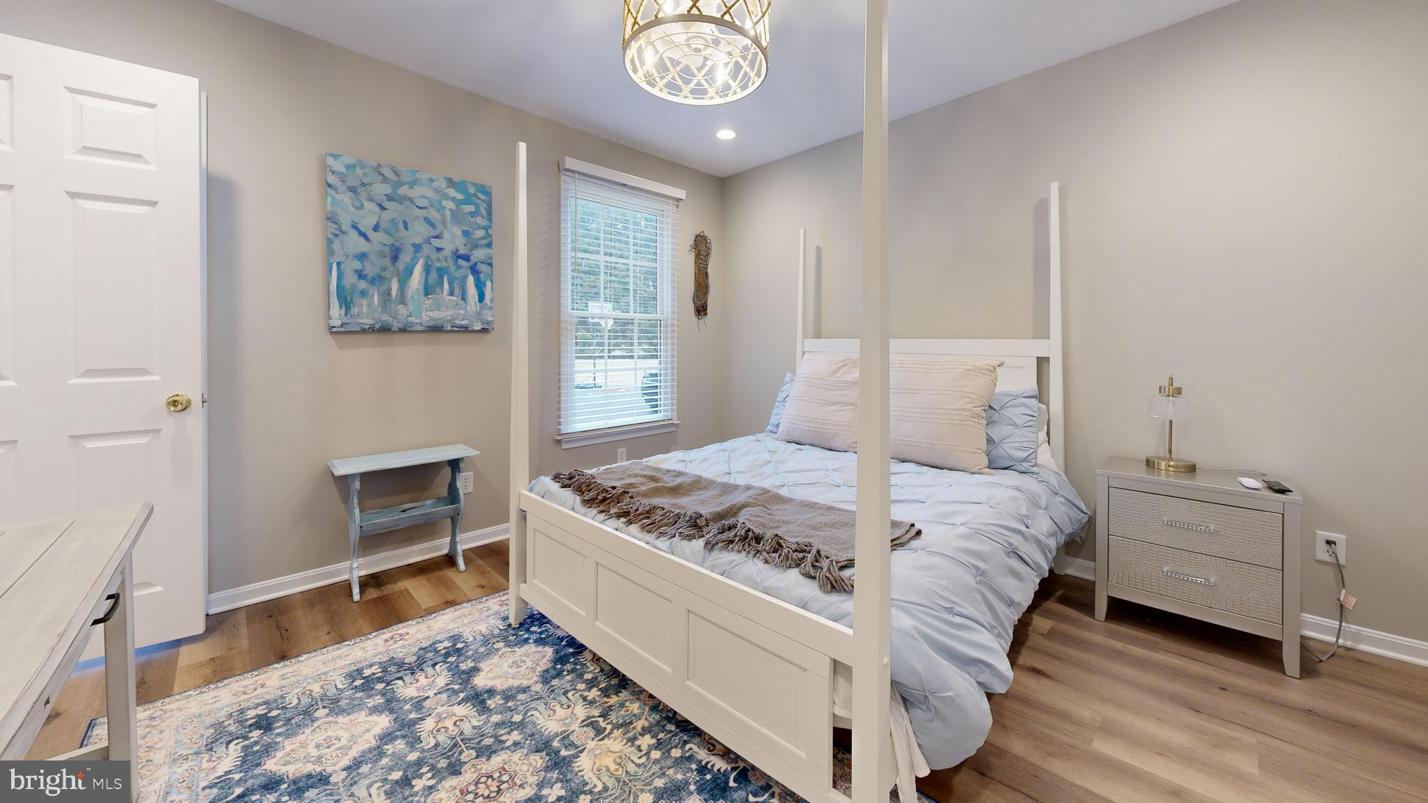 28715 Jacks Field Road Wye Mills, MD 21679 - Photo 20 of 27 a bedroom with a bed and a table in it