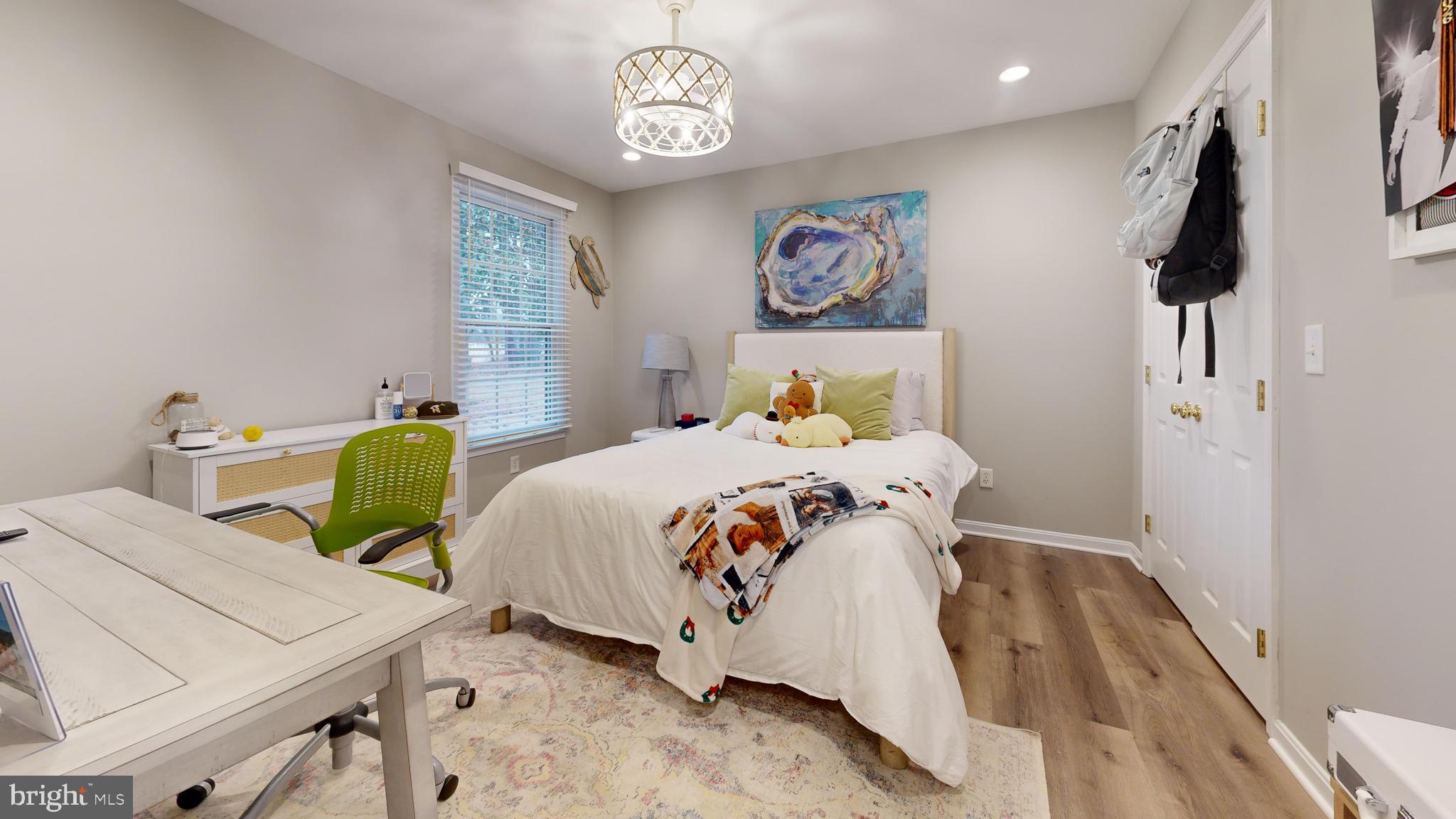28715 Jacks Field Road Wye Mills, MD 21679 - Photo 21 of 27 a bedroom with a bed and a table in it