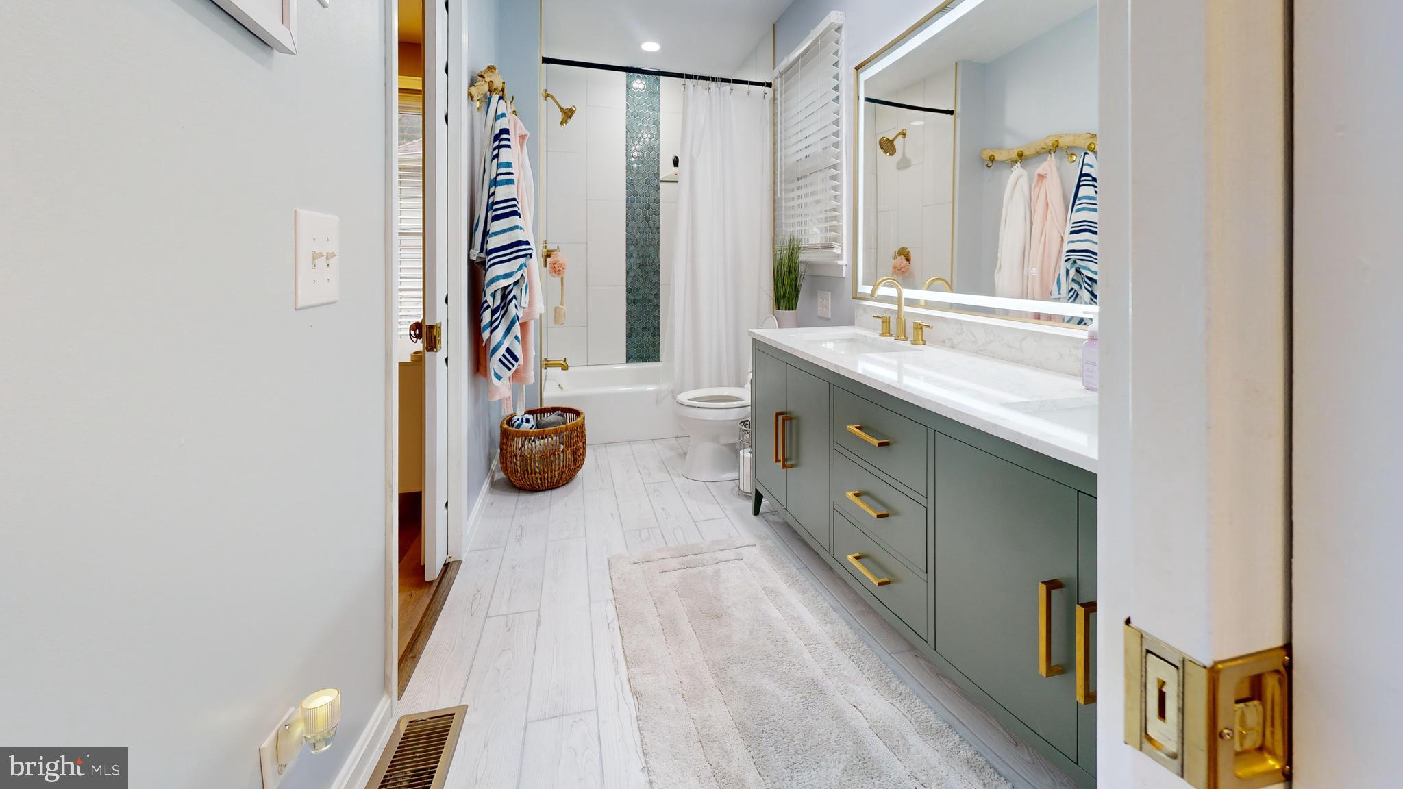 28715 Jacks Field Road Wye Mills, MD 21679 - Photo 9 of 27 a bathroom with a double vanity sink toilet and shower