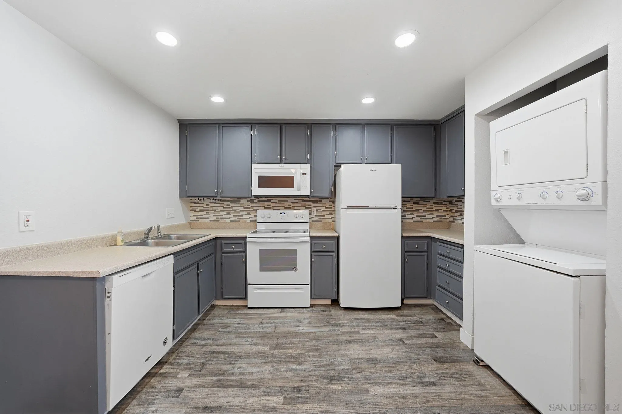293 Sycamore Road, Unit 15 San Ysidro, CA 92173 - Photo 9 of 25 a kitchen with a sink a refrigerator and cabinets