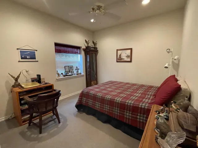 a bedroom with a bed and a dresser