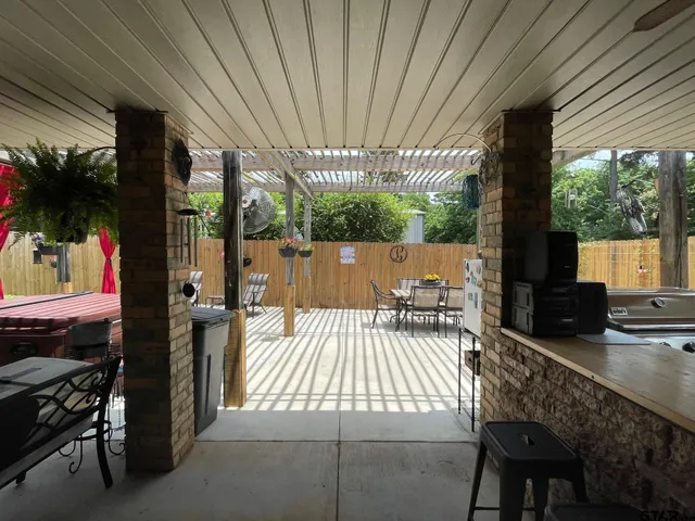 a living room with furniture a ceiling fan and a rug