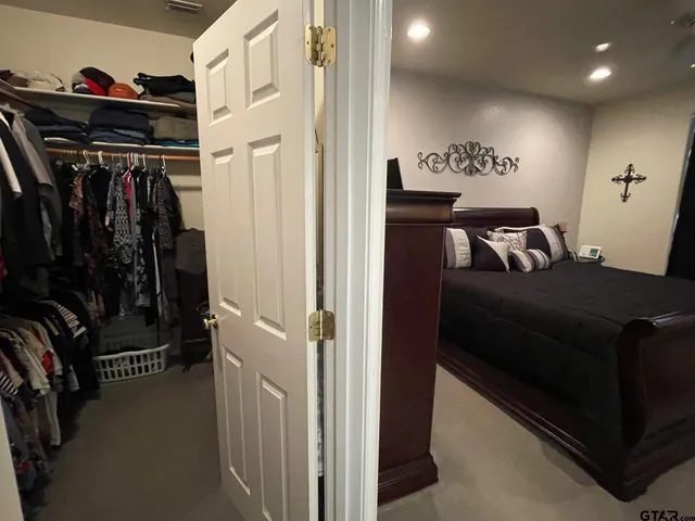 a view of walk in closet with clothes