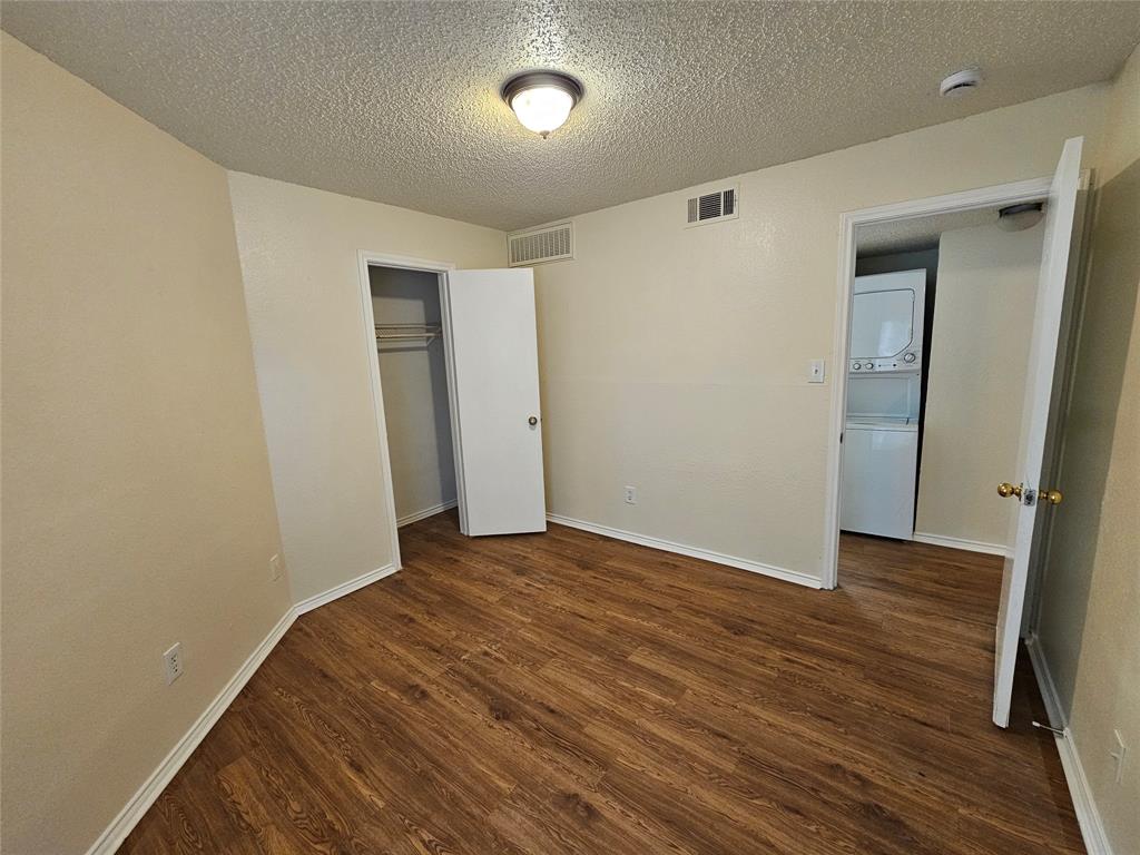 9823 Walnut Street, Unit 208 Dallas, TX 75243 - Photo 11 of 16 a view of an empty room with wooden floor