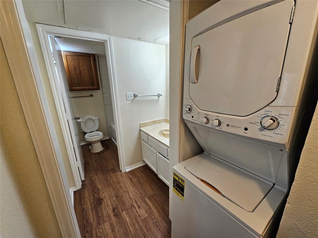 9823 Walnut Street, Unit 208 Dallas, TX 75243 - Photo 8 of 16 a view of washer and dryer with wooden floor