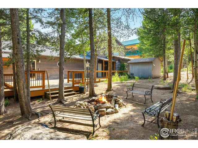 a view of a patio with table and chairs next to a yard