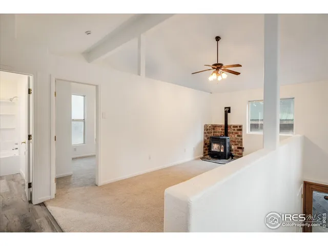 a view of a livingroom with furniture and a ceiling fan
