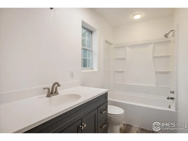 a bathroom with a sink a toilet a shower and a mirror