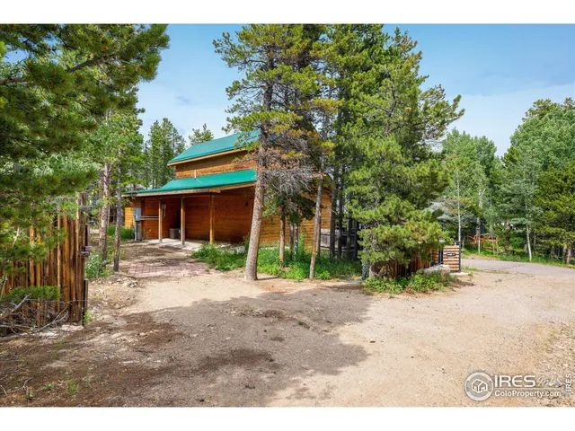 a view of a house with a tree in the background