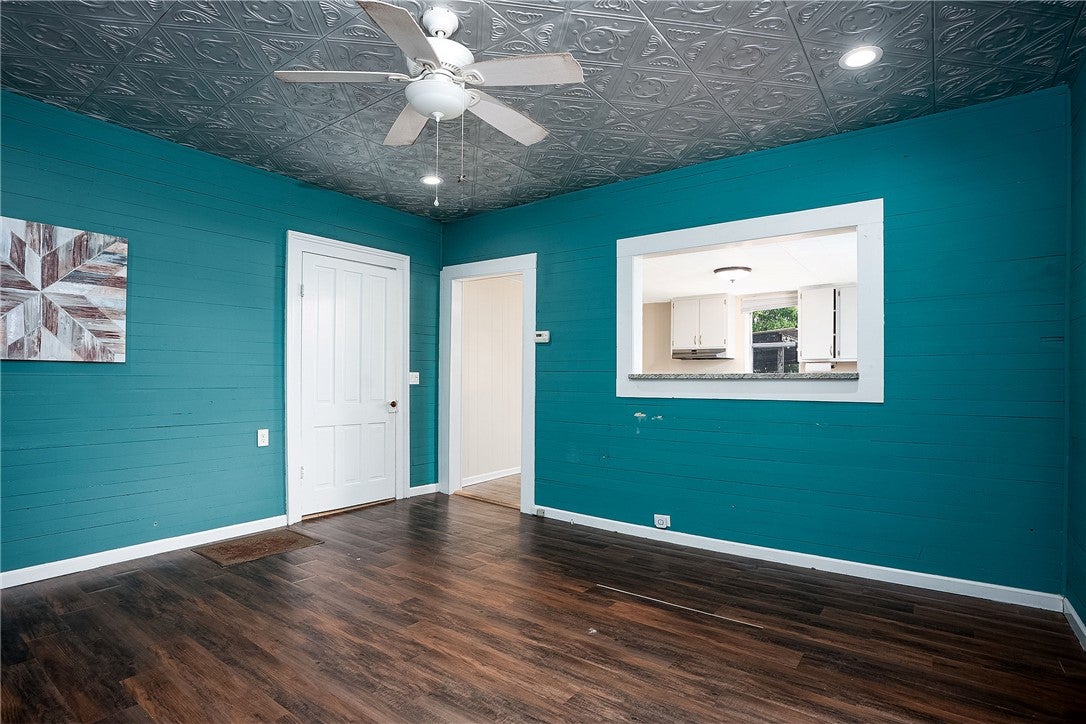 59 Church Street Notasulga, AL 36866 - Photo 32 of 38 This vibrant room features rich flooring and a unique patterned ceiling.