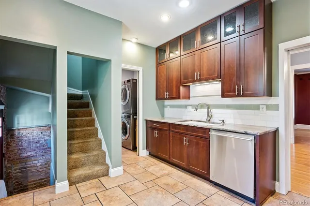 a kitchen with sink cabinets and stainless steel appliances
