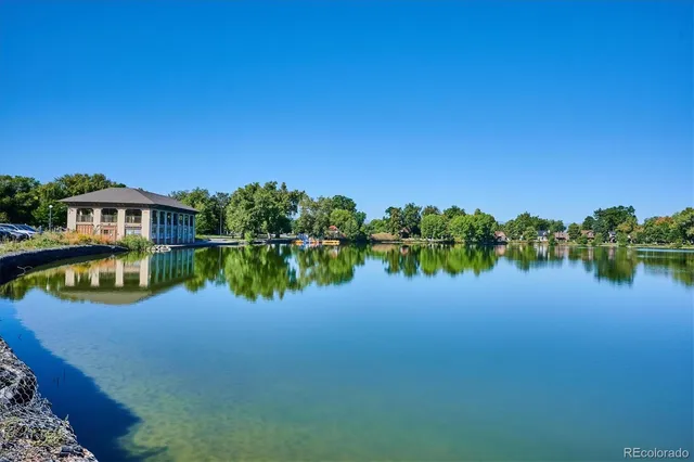 a front view of a building with retail shop and a couple of people