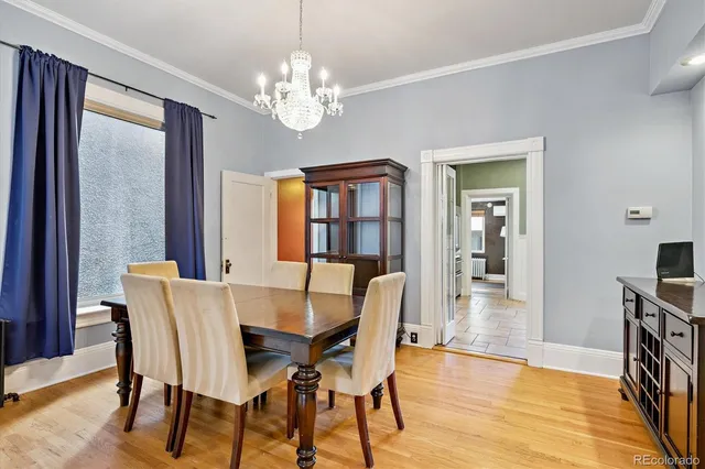 a view of a dining room with furniture wooden floor and chandelier