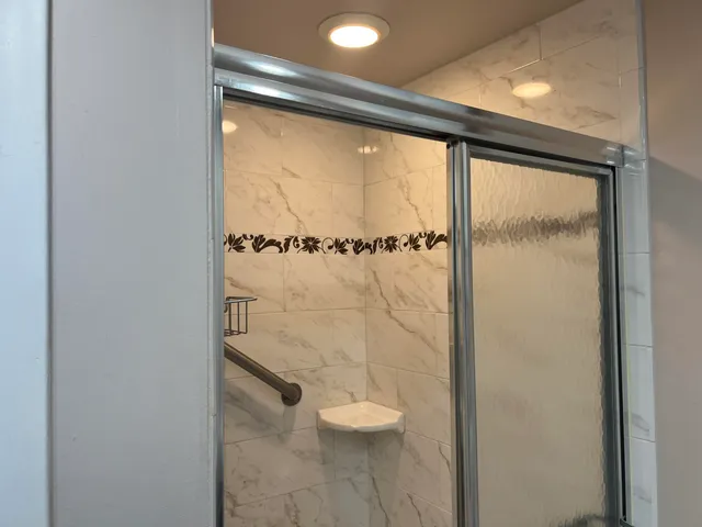 a bathroom with a glass shower door