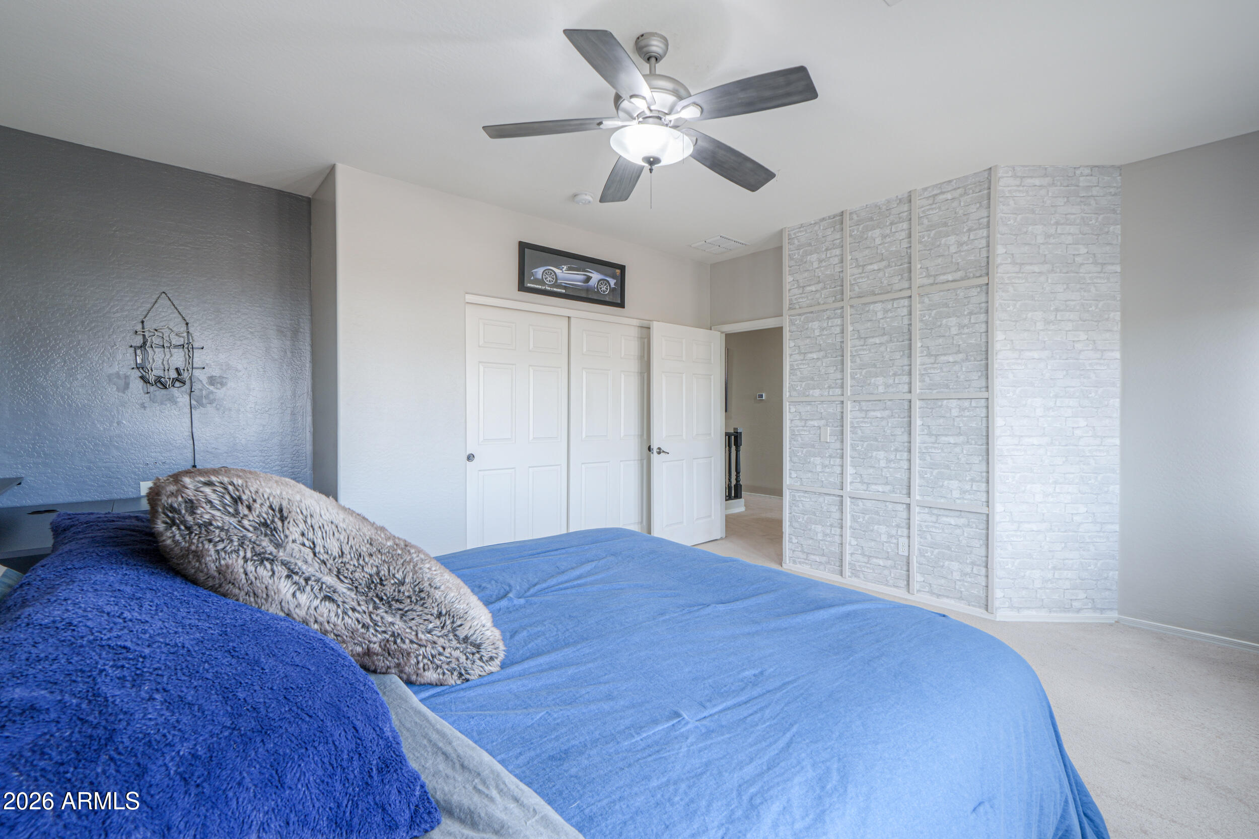 45247 West Jack Rabbit Trail Maricopa, AZ 85139 - Photo 48 of 75 a bedroom with a large bed and a chandelier