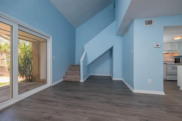 a view of entryway and hall with wooden floor