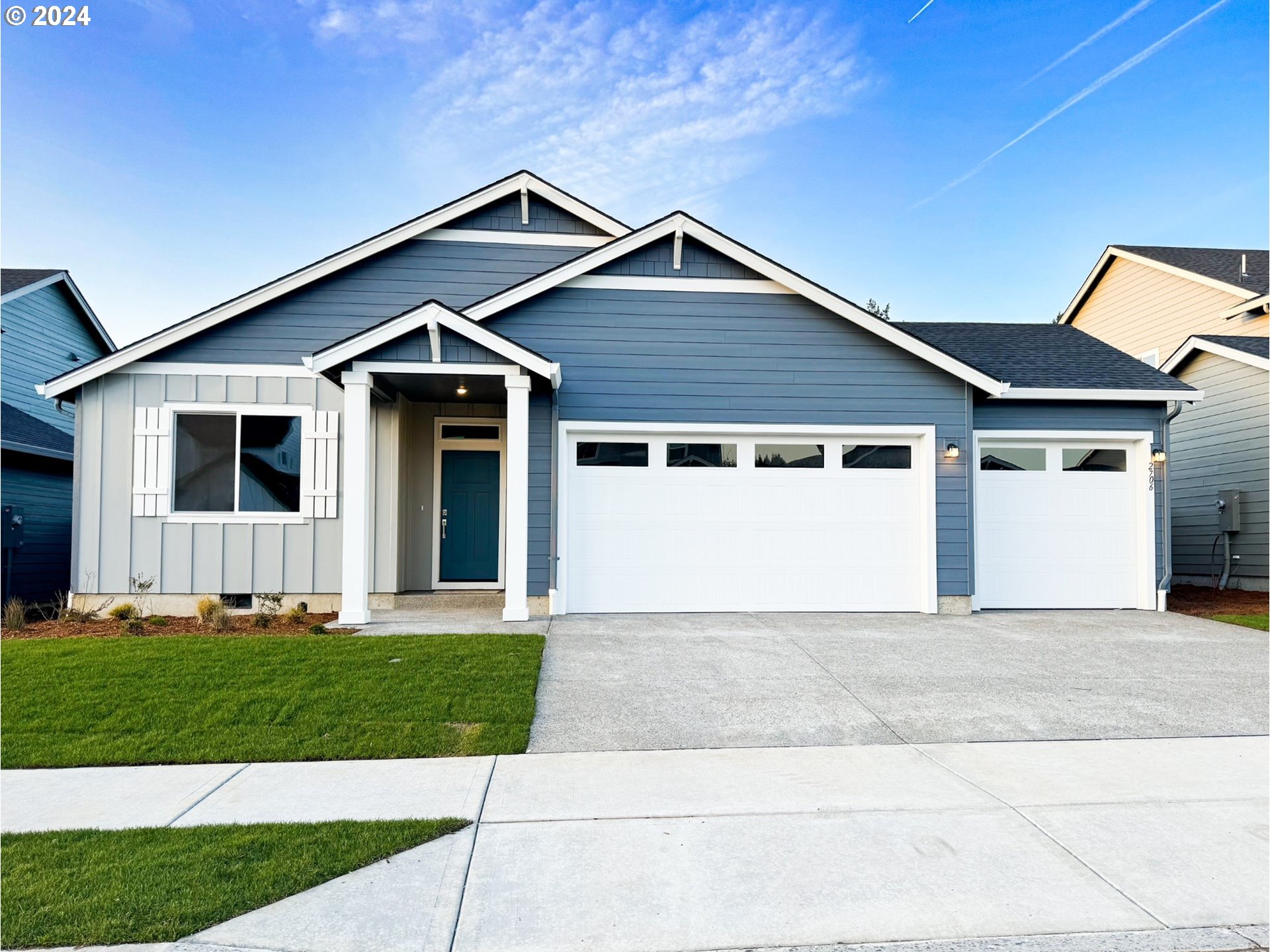 2706 South 7th Circle Ridgefield, WA 98642 - Photo 1 of 26 a front view of a house with a yard and garage