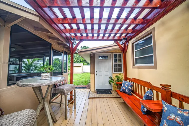 a outdoor sitting area with furniture and wooden floor