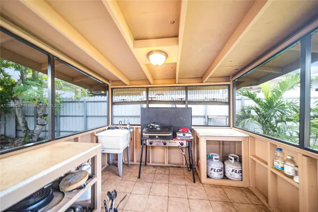 a view of balcony with wooden floor and potted plants