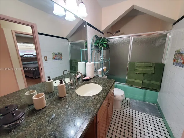 a bathroom with a toilet a sink and shower