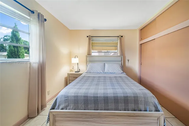 a bed room with a bed and a window