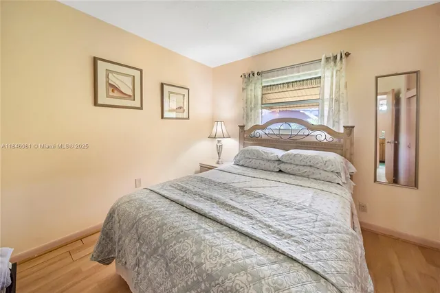 a bedroom with a bed and a night stand