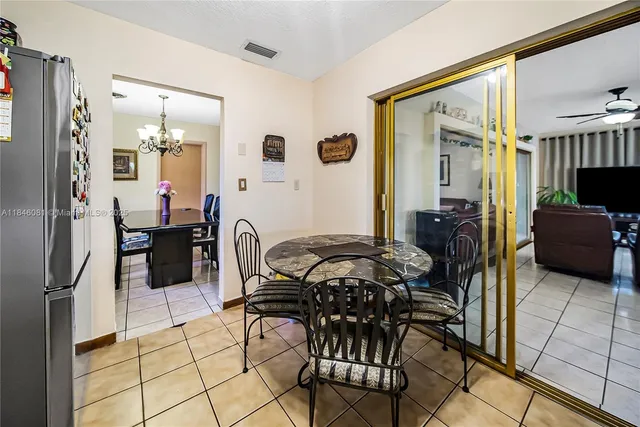 a kitchen with a refrigerator and a stove top oven