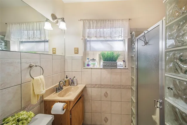 a kitchen with a stove a sink and cabinets