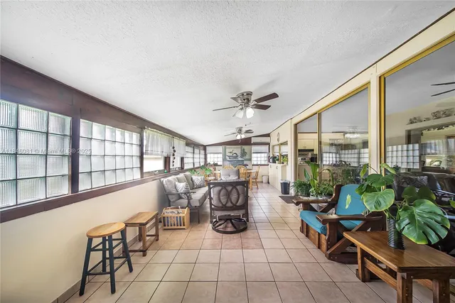 a bedroom with furniture and a large window
