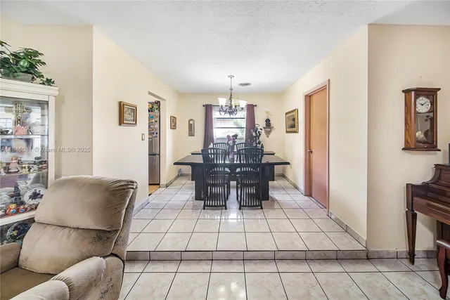 a living room with furniture and flowers