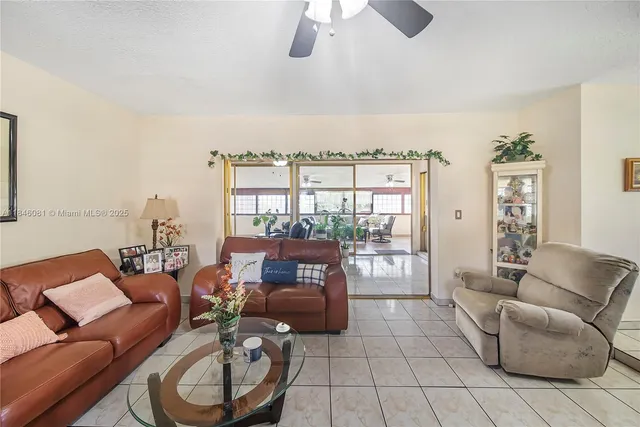 a living room with furniture and a floor to ceiling window