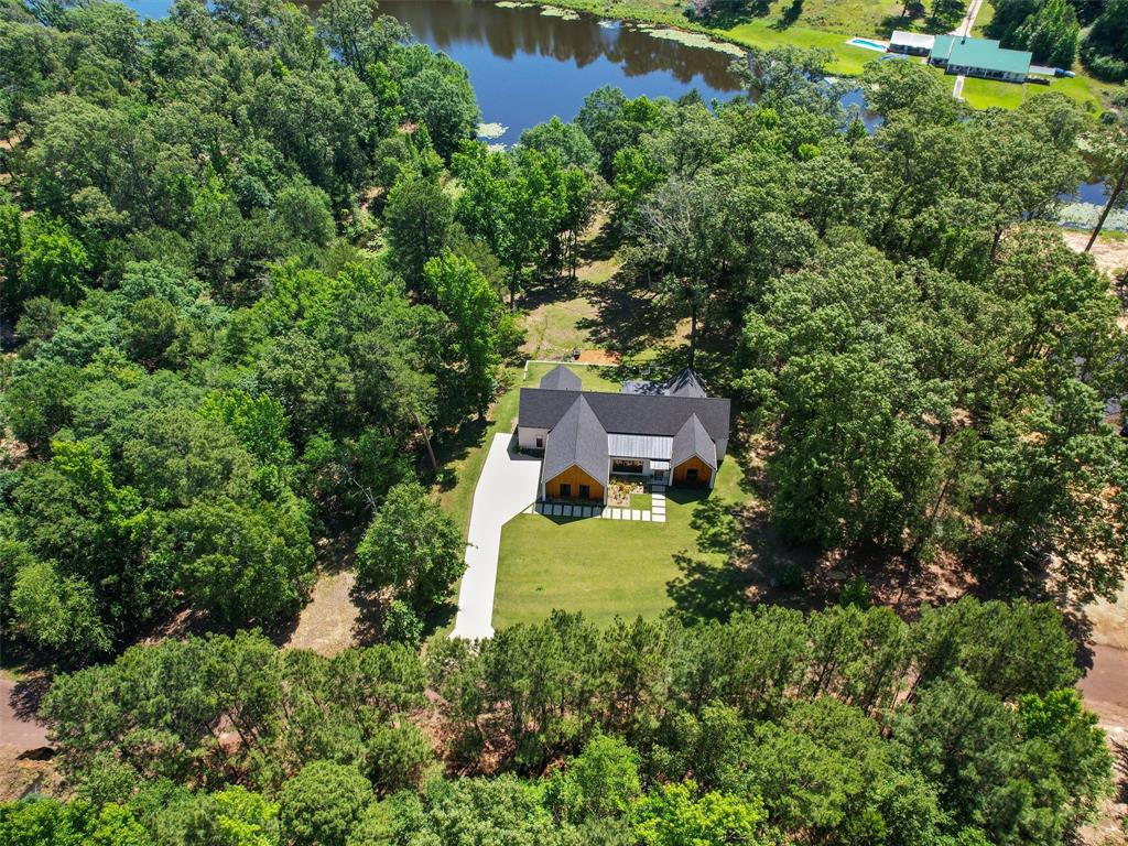 an aerial view of a house with a yard