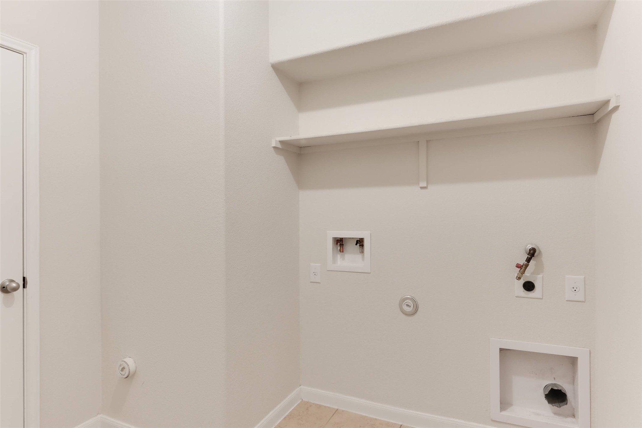 18705 Moreto Loop Pflugerville, TX 78660 - Photo 18 of 21 A dedicated laundry space provides practical built-in shelving and essential hookups for convenience.