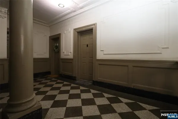 a room with a black white checkered floor with a black white checkered floor and a stove
