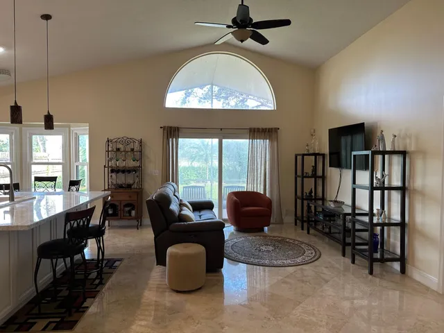 a living room with furniture a window and a chandelier