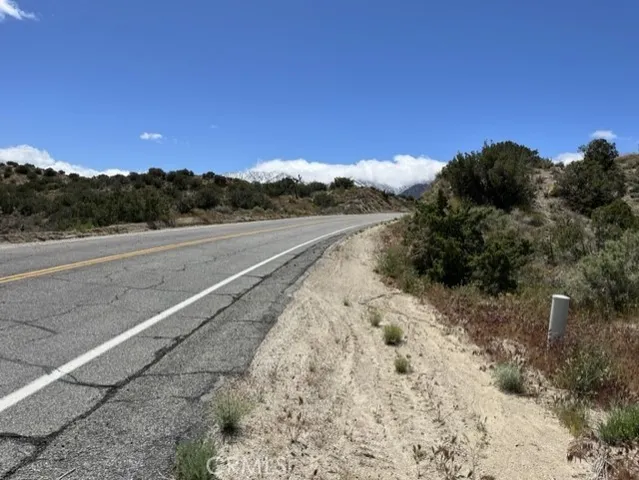 a view of a road with a mountain in the background