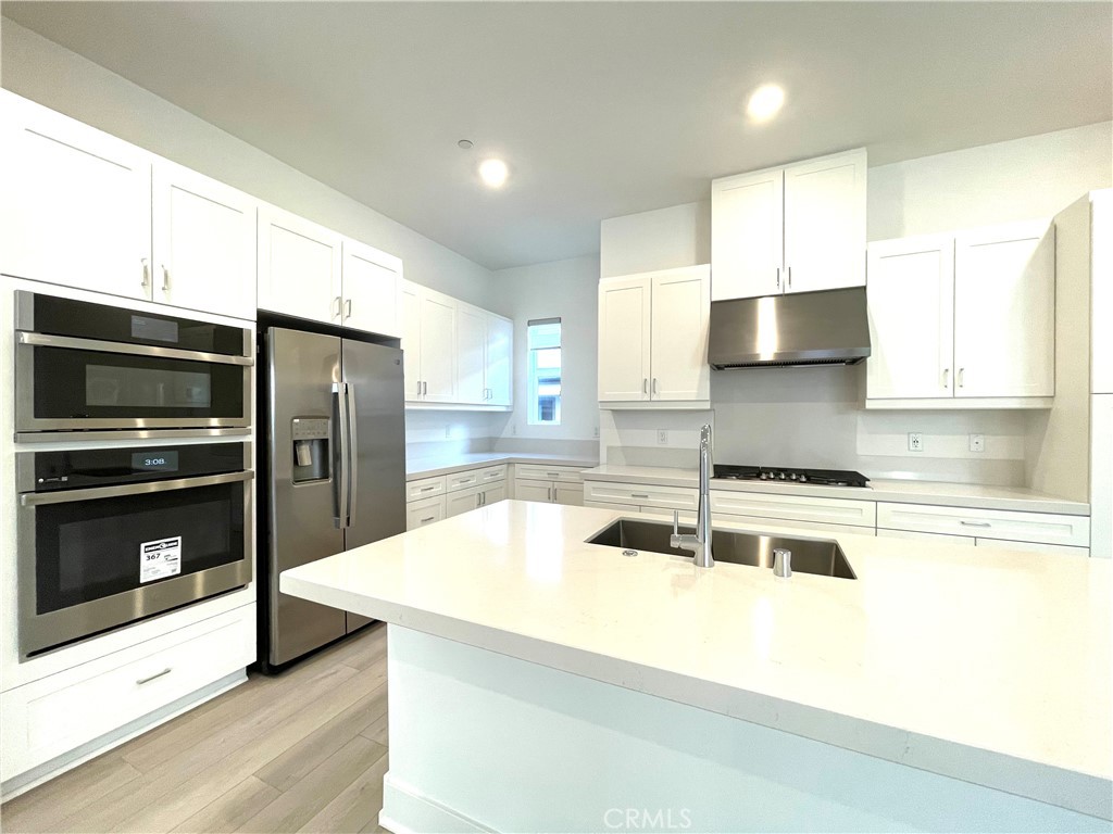 516 Neilson Irvine, CA 92618 - Photo 11 of 21 a kitchen with stainless steel appliances a stove a sink and a refrigerator