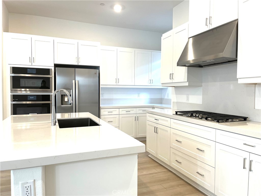 516 Neilson Irvine, CA 92618 - Photo 12 of 21 a kitchen with stainless steel appliances a stove a refrigerator and cabinets