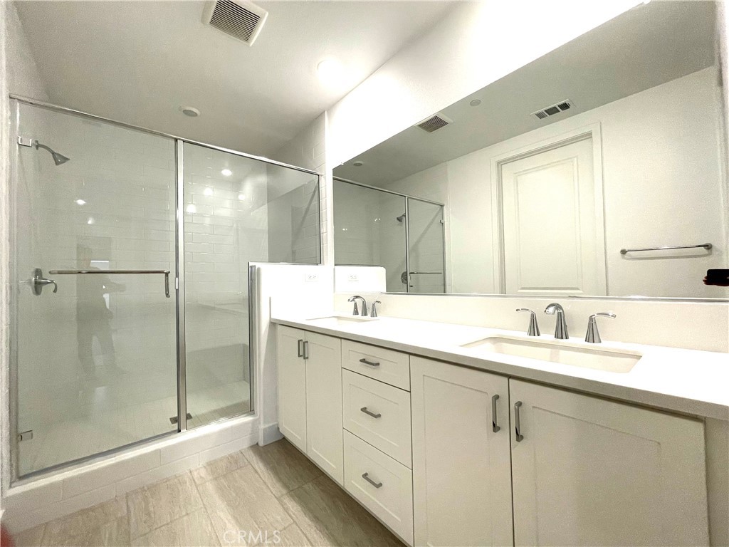 516 Neilson Irvine, CA 92618 - Photo 18 of 21 a bathroom with a shower sink and mirror