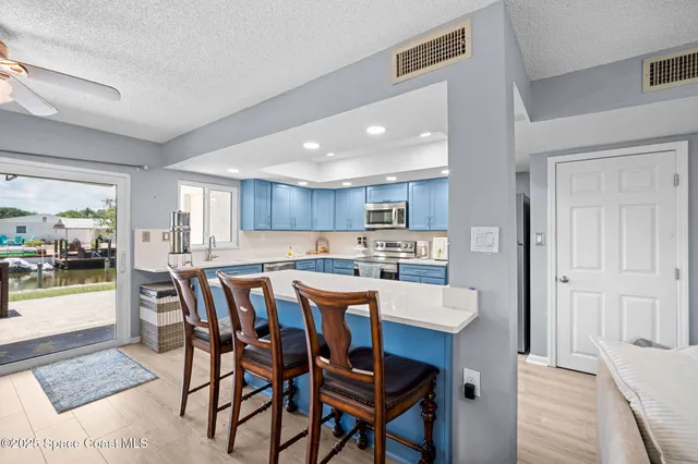 a kitchen with sink and wooden floor