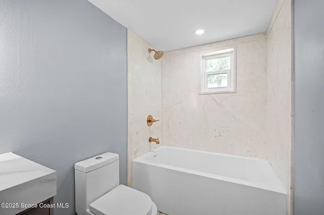 a bedroom with furniture and a chandelier