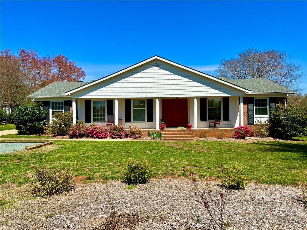 13701 Thompson Road Mint Hill, NC 28105 - Photo 1 of 25 a front view of a house with a yard patio and green space