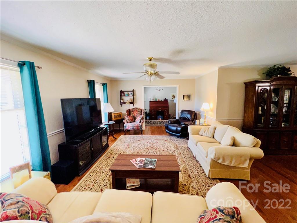 13701 Thompson Road Mint Hill, NC 28105 - Photo 13 of 25 a living room with furniture a rug and a flat screen tv