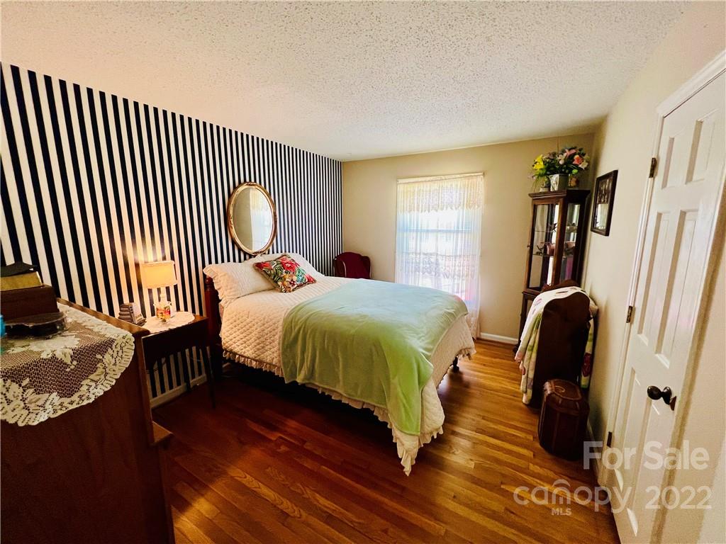 13701 Thompson Road Mint Hill, NC 28105 - Photo 17 of 25 a bedroom with a bed and a mirror