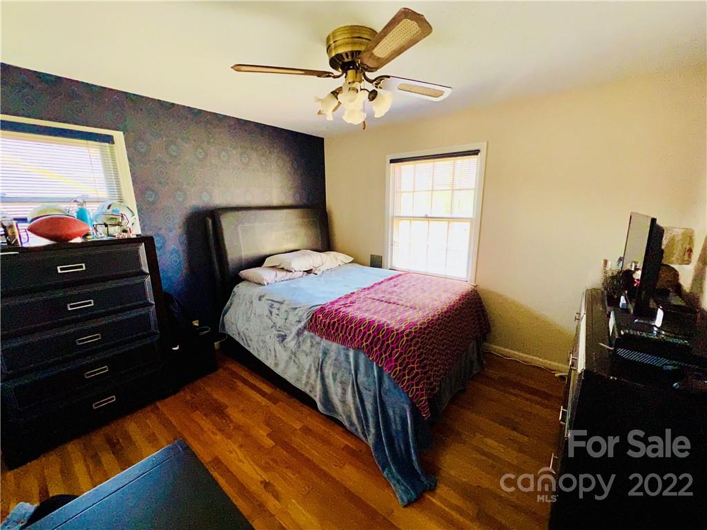 13701 Thompson Road Mint Hill, NC 28105 - Photo 18 of 25 a bedroom with a bed and a chandelier